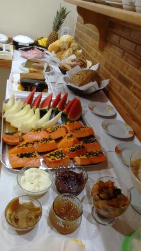 a table topped with lots of different types of food at Pousada Recanto das Águas in Lumiar