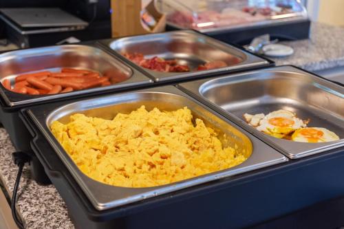 a buffet with several trays of food on a counter at Pension Hosnar, apartma Gusto in Bovec