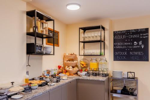 a kitchen with a counter with food on it at Pension Hosnar, apartma Gusto in Bovec