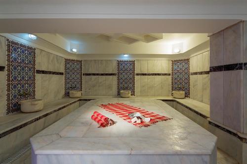 a room with a table with red objects on it at Club Turtas Beach - All Inclusive in Konaklı