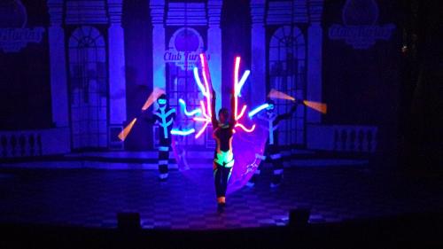 a group of people walking on a stage with lights at Club Turtas Beach - All Inclusive in Konaklı