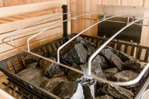 a basket full of rocks in a bath tub at A Casa Residenz in Sölden