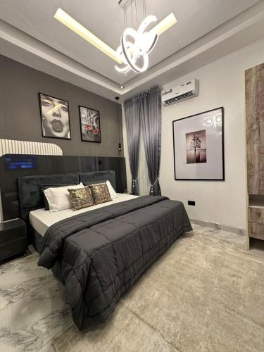 a bedroom with a large bed and a ceiling fan at Brand New 2 Bedroom Apartment in Lekki