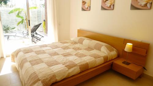 a bedroom with a large bed with a lamp and a window at Saval Spa Aqquaria Family Complex in Salou