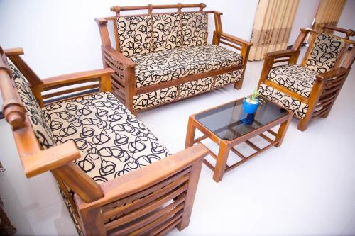 a group of chairs and a table in a room at Gin Green Villa in Galle