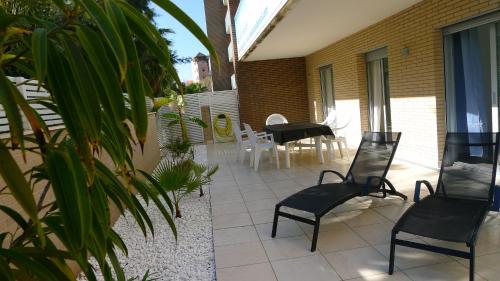 a patio with chairs and a table on a house at Saval Spa Aqquaria Family Complex in Salou