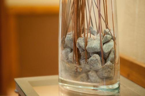 a glass vase with rocks in it on a table at Hotel Florido in Sort
