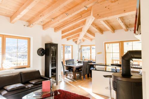 a living room with a couch and a table at A Casa Residenz in Sölden