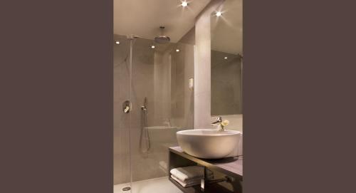a bathroom with a sink and a shower at Hotel Désirée - Garda Lake Collection in Sirmione
