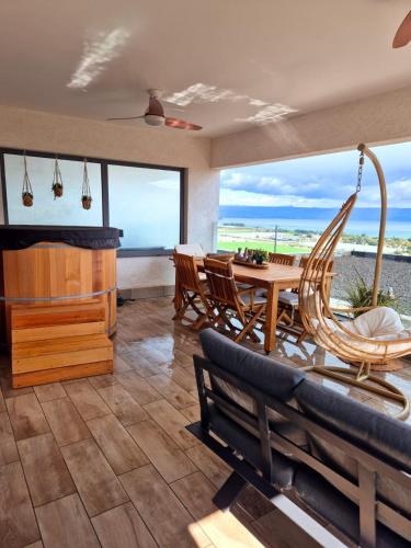 a living room with a hammock and a table and chairs at הדירה- C Lake, סי כנרת in Migdal