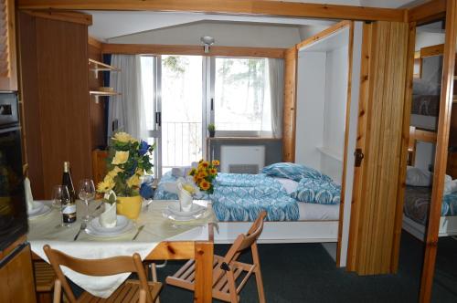 a living room with a table and a bed at Residence Il Vigo di Marilleva in Marilleva