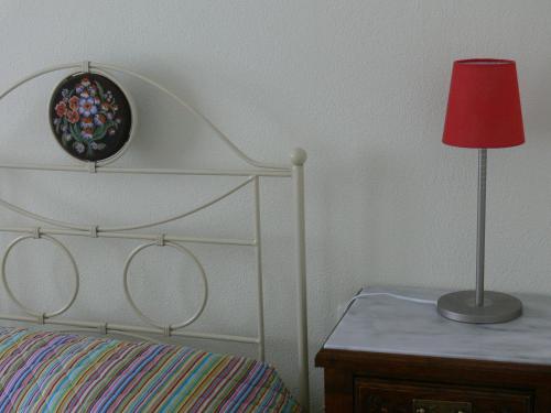 a bedroom with a bed and a lamp on a table at Alkyon Villas in Sivota