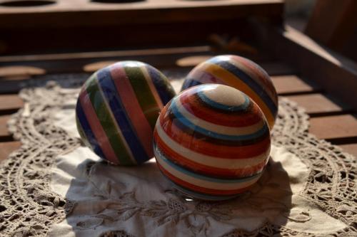two striped easter eggs sitting on top of a table at Alkyon Villas in Sivota
