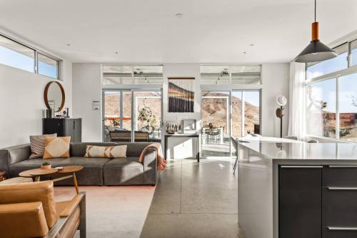a kitchen and living room with a couch and a table at Steel & Solace By The Cohost Company in Pioneertown