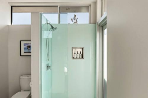 a shower with a glass door in a bathroom at Steel & Solace By The Cohost Company in Pioneertown
