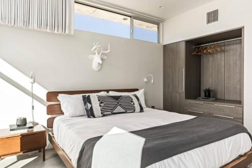 a bedroom with a large bed and a window at Steel & Solace By The Cohost Company in Pioneertown