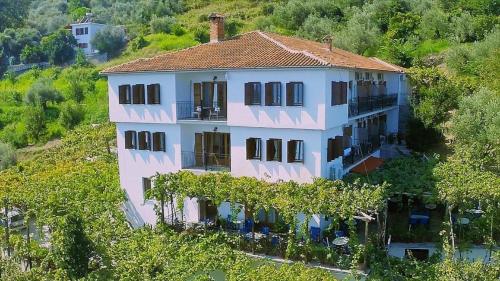 a large house on a hill with trees at Hotel Agnadi - Horefto in Chorefto
