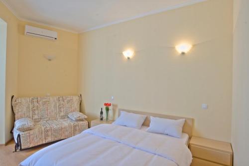 a bedroom with a large bed and a couch at Heart Kyiv Apart-Hotel in Kyiv