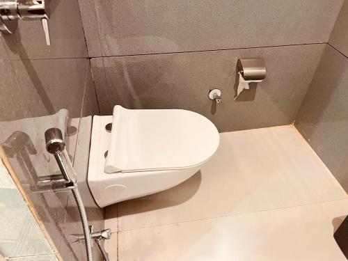 a bathroom with a white toilet in a stall at Siyavar Palace in Orchha