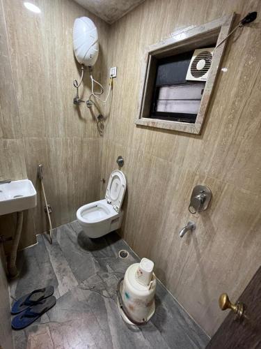 a bathroom with a toilet and a sink at Sidra Guest House in Kolkata