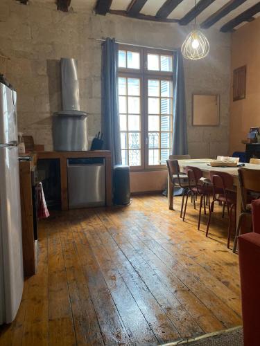 Cette chambre comprend une cuisine et une table avec des chaises. dans l'établissement Grand Appartement historique Rue Colbert, à Tours