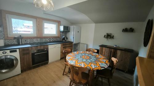 une cuisine avec une table sur laquelle est peinte une fleur dans l'établissement ski chamonix, Saint Gervais et mont-blanc, à Passy