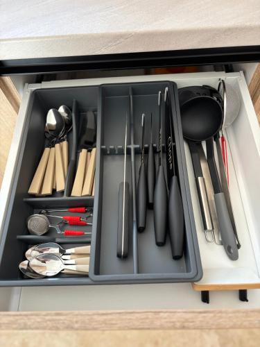 a drawer filled with cooking utensils at Daheim in Râşnov