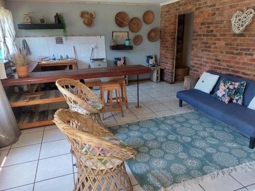a living room with a couch and a table at Rustique in Graskop