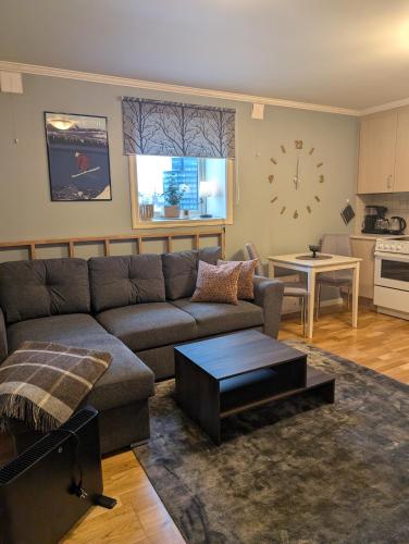 a living room with a couch and a table at The Garage in Narvik