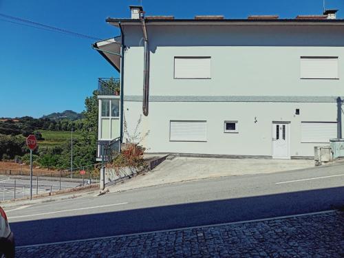 a white building on the side of a street at Casa da Angelina in Ponte da Barca