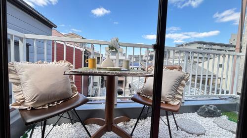 a balcony with a table and chairs on a balcony at 桜の宿-大阪城Osaka castle-105m2 private-5Way access-KIX USJ 難波心斎橋 Direct in Osaka