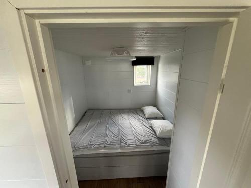 a small bedroom with a bed in a small room at Suncity Solsidan in Borgholm