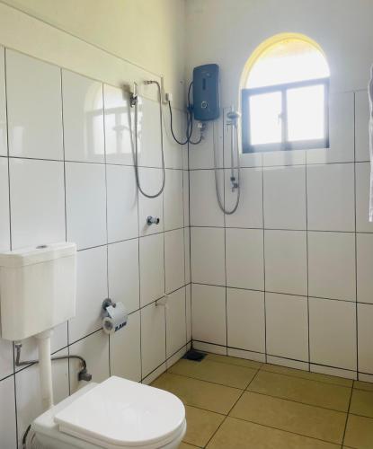 a bathroom with a shower and a toilet at Island House Hiriketiya in Dickwella