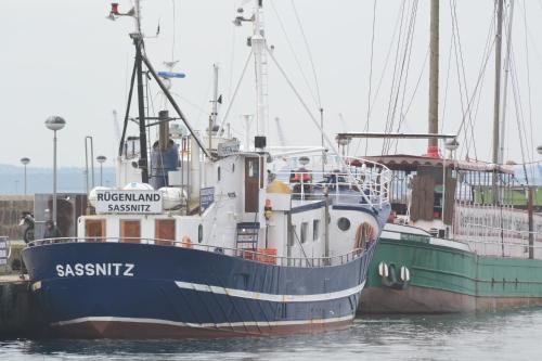 two boats docked at a dock in the water at Ferienwohnung Nordseeliebe in Rysum