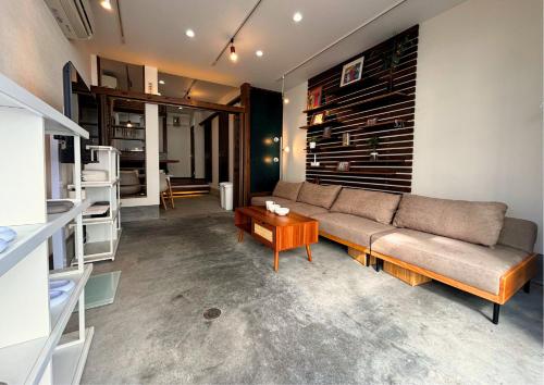 a living room with a couch and a table at Asakusa Sky House in Tokyo