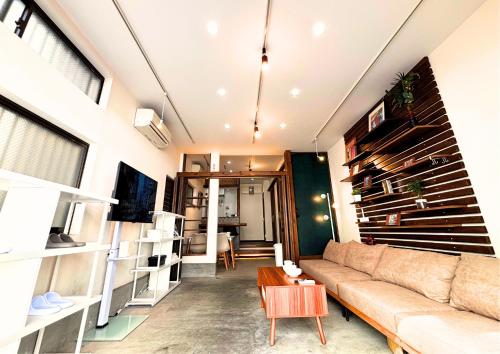 a living room with a couch and a table at Asakusa Sky House in Tokyo
