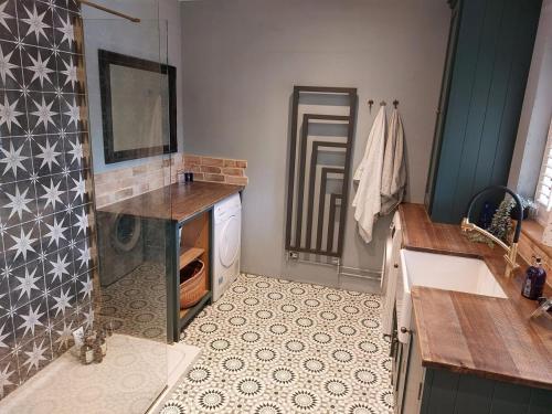 a bathroom with a sink and a washing machine at Countryside Retreat with Hot Tub in Haselbury Plucknett