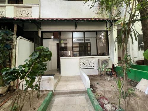 a house with a bench in the middle of a garden at Paradise Beach Apartment in Boracay