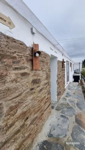 a stone wall on the side of a building at Piscina Interior aquecida - Monte Cimeiro e Casitas da Eira - Casa da Ti Carminha in Mação