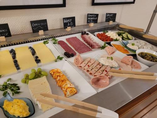 a buffet with many different types of meats and cheese at Hotel Thesdorfer Hof in Pinneberg