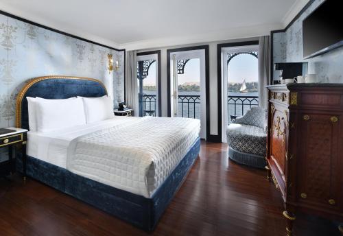 a bedroom with a bed and a balcony at Movenpick SS Misr Steamer Nile Cruise - 04 & 07 Nights Each Monday From Luxor and 03 Nights Each Friday from Aswan in Luxor