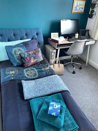 a bedroom with a bed and a desk with a computer at Peverell Loft Retreat in Plymouth