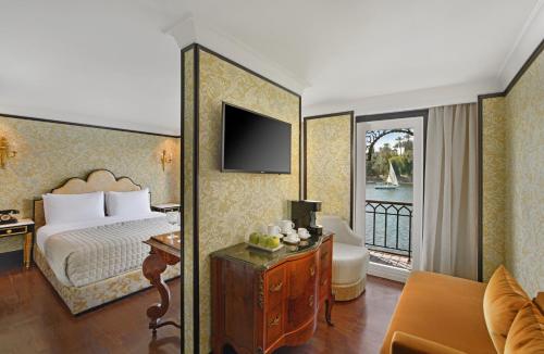 a hotel room with a bed and a balcony at Movenpick SS Misr Steamer Nile Cruise - 04 & 07 Nights Each Monday From Luxor and 03 Nights Each Friday from Aswan in Luxor