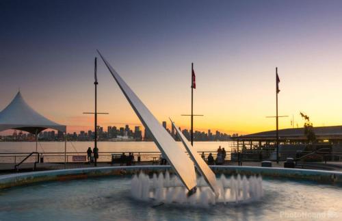 a fountain in the water in front of a city at Luxury Scandinavian Suite Cozy and Bright in North Vancouver