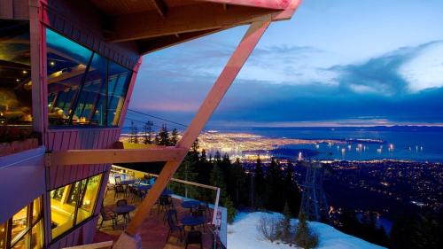 a view of the city from a balcony of a ski lodge at Luxury Scandinavian Suite Cozy and Bright in North Vancouver