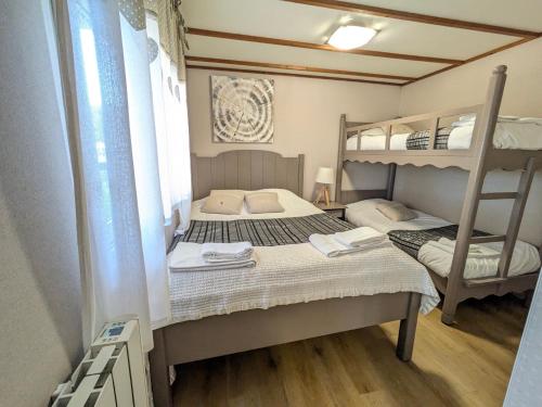 a bedroom with two bunk beds and a ladder at Chateau de Quesmy in Quesmy