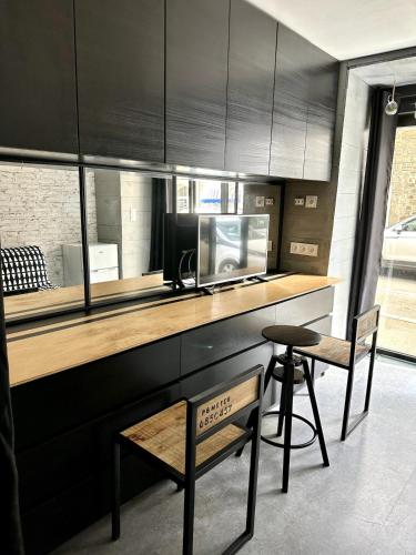 une cuisine avec un comptoir, un four micro-ondes et un tabouret dans l'établissement Le Loft centre Paramé avec coin extérieur, à Saint-Malo