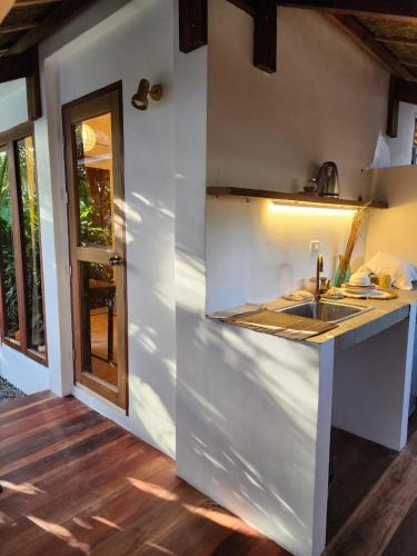 a kitchen with a sink and a counter top at Prana Siargao Resort in General Luna