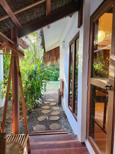 an open door of a house with a pathway at Prana Siargao Resort in General Luna