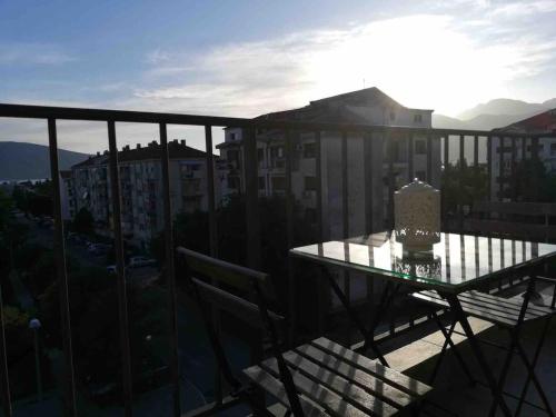 a balcony with a table and a view of a city at Tivat apartman in Tivat
